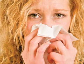 women sneezing from pet allergies